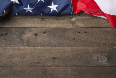 Low angle view of flag against blue wall