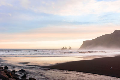 Scenic view of beach against sky during sunset