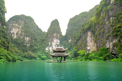 Scenic view of lake with mountain range in background