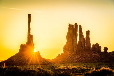 Sun shining through rocks during sunset