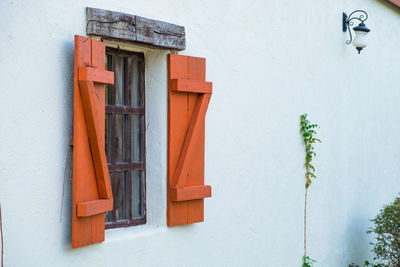 Wood window on white cement wall, vintage style - image