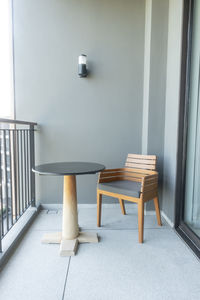 Empty chairs and table against wall at home