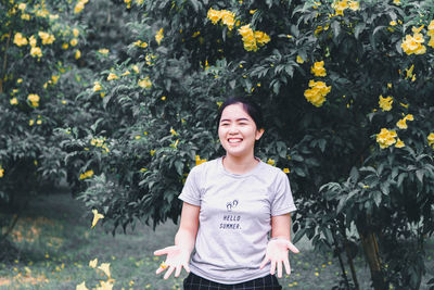 Portrait of smiling girl standing by plants