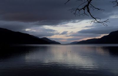 Scenic view of lake against dramatic sky