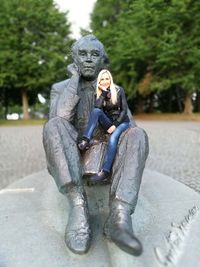 Statue of man sitting on sculpture