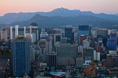 Cityscape against mountains at dusk