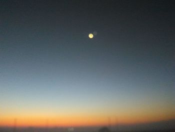 Low angle view of moon against sky at sunset