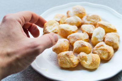 Close-up of hand holding dessert