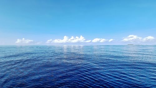 Scenic view of sea against blue sky