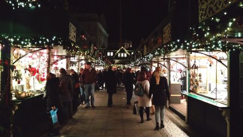 People at illuminated market stall