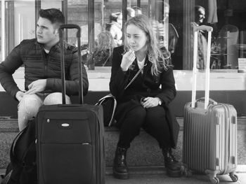 Full length of people sitting in train