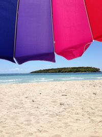 Scenic view of beach against cloudy sky