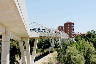 View of bridge and buildings against sky