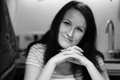 Portrait of young woman smiling at home