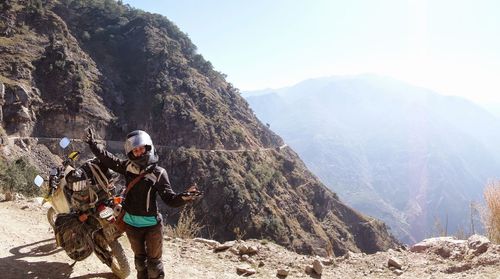 Man on mountain against clear sky