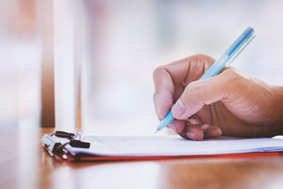 Close-up of woman hand on table