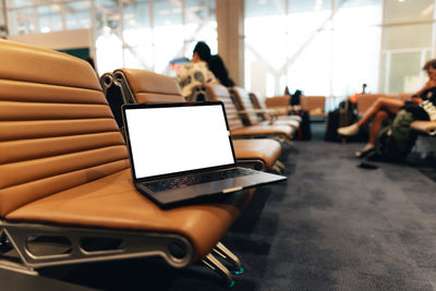 Midsection of woman using laptop on table