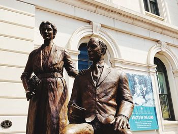 Low angle view of statue against historic building