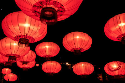 Low angle view of illuminated lanterns hanging at night