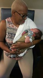 Close-up of father holding baby hand