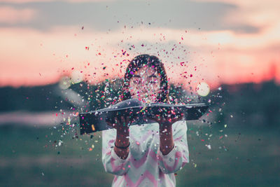 Close-up of wet girl against sky