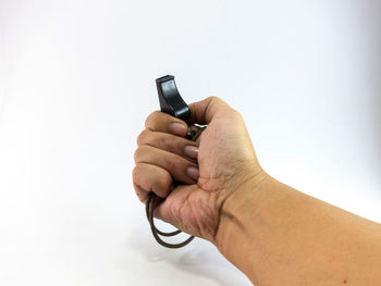 Close-up of person holding hands against white background