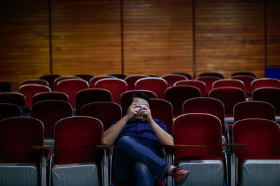 Full length of woman sitting on chair