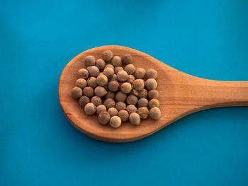 High angle view of eggs in container against blue background