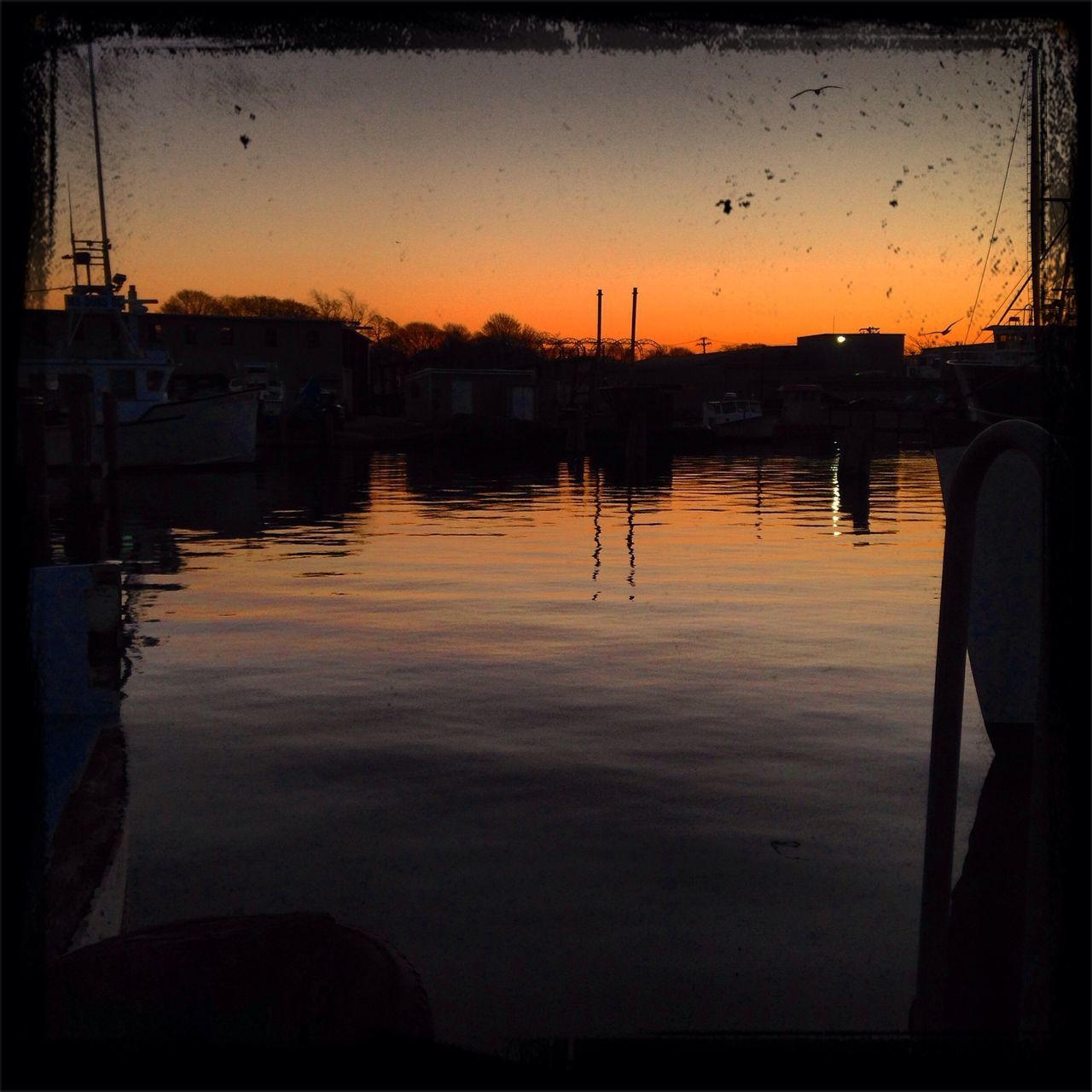 sunset, water, silhouette, reflection, sky, orange color, built structure, architecture, building exterior, lake, river, waterfront, harbor, tranquility, scenics, tranquil scene, nautical vessel, nature, dusk, beauty in nature