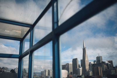 Cityscape against cloudy sky