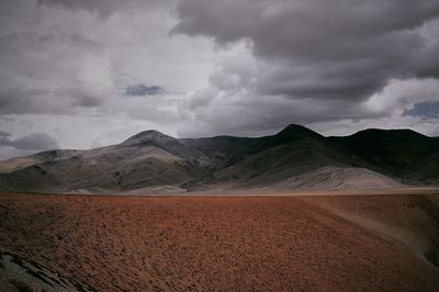 Scenic view of mountains against cloudy sky