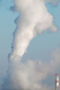 Low angle view of smoke stack against sky