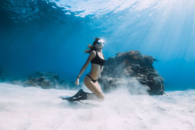 Rear view of woman swimming in sea