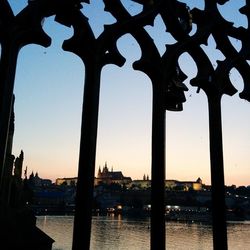 Built structure in water at sunset