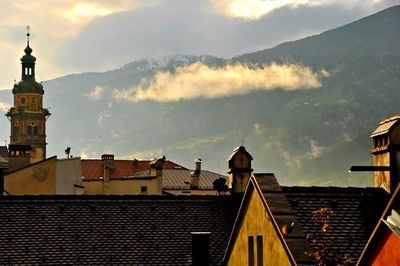 Houses against cloudy sky