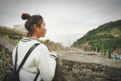 Side view of young woman looking away