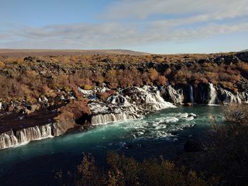 Scenic view of waterfall against sky