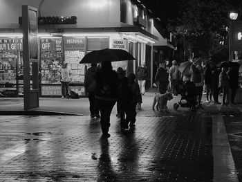 People walking on wet street in rain