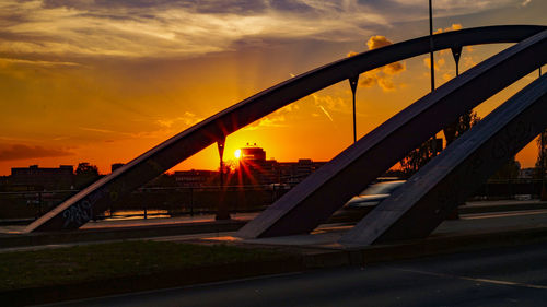 Bridge against sky during sunset in city