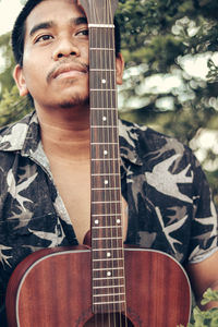 Portrait of man playing guitar