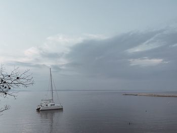 Ship sailing on sea against sky