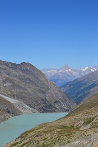 Scenic view of mountains against clear blue sky