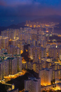 Aerial view of illuminated buildings in city at night