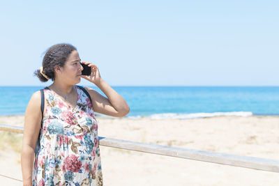 Side view of woman standing at beach