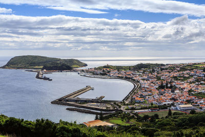  high angle view of cityscape and harbor against the sky