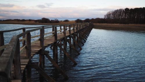 Pier over sea against sky