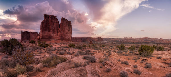 Panoramic view of rock formations against sky during sunset