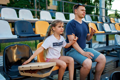 Father and daughter watching soccer match