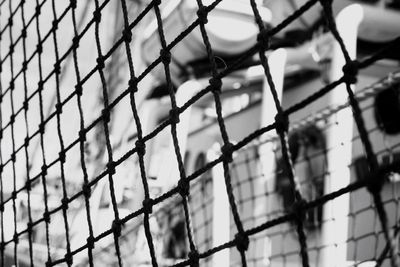 Low angle view of chainlink fence against sky