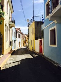 Street amidst houses against sky